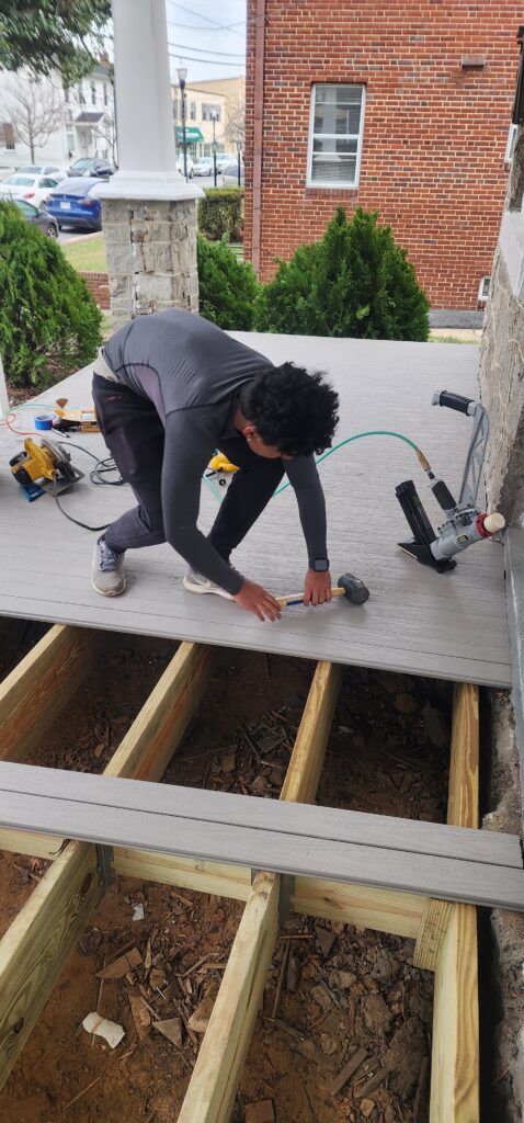Professional deck contractor in Laurel, MD installing a custom backyard deck with quality materials.