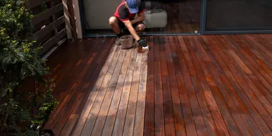 Deck cleaning and sealing service with a contractor power‑washing and protecting wood surfaces.