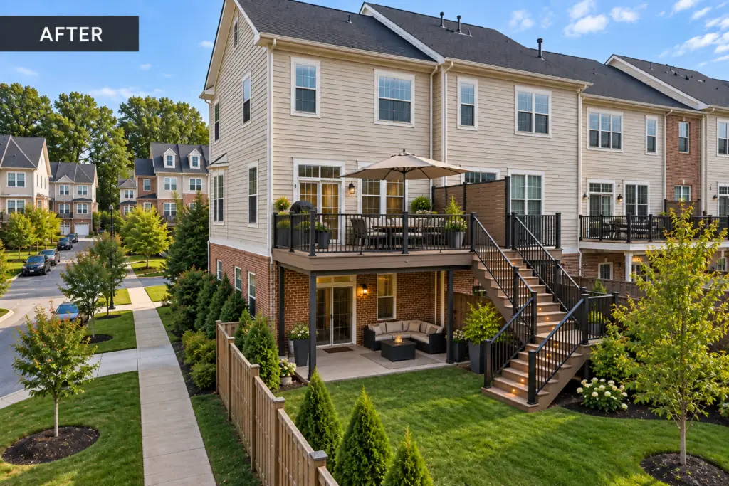 Completed composite deck in Redland, MD with modern black railings, stairs, outdoor seating, and landscaped townhouse