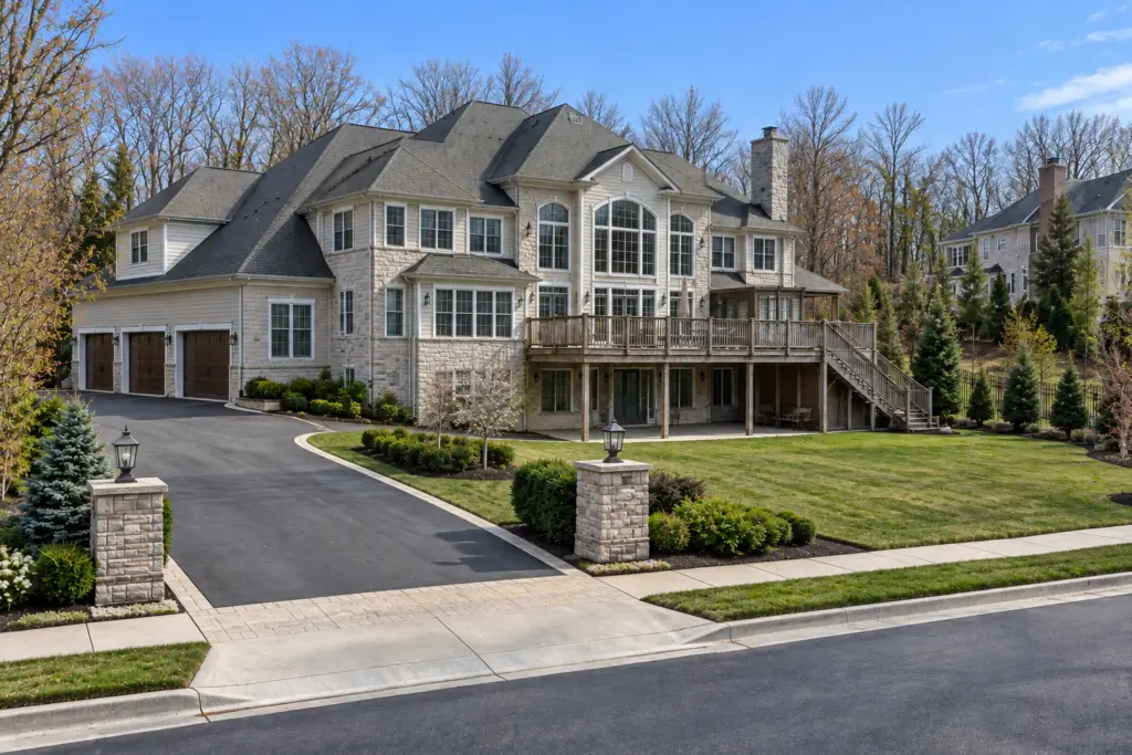 Before composite deck builder project in North Potomac, MD showing an aging elevated wood deck and luxury home